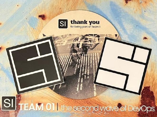 A System Initiative postcard with a coaster and stickers on top.